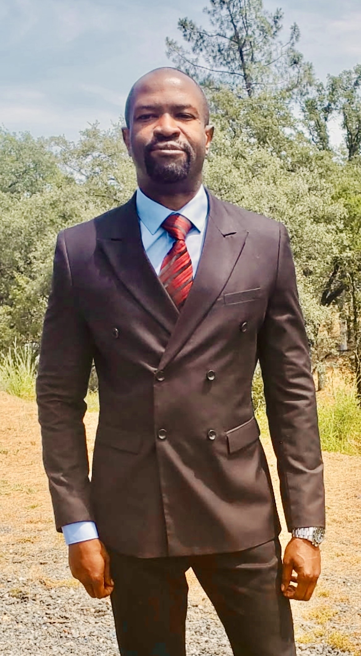 Ralph Nwobi in a double-breasted suit outdoors